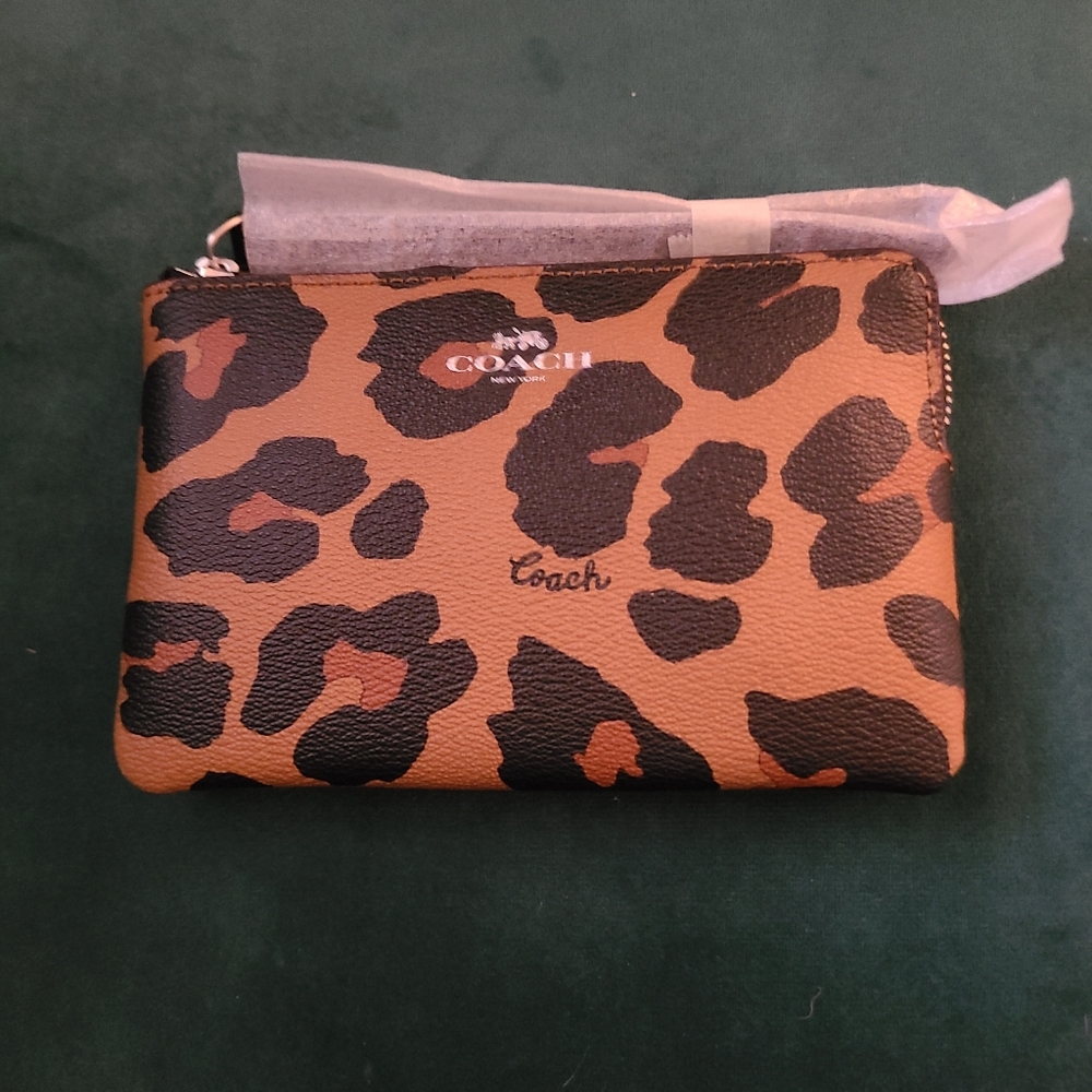 Coach wristlet. Color-Tan animal print. New with tags.